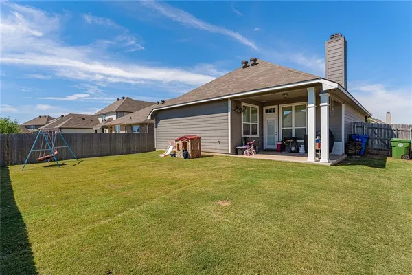 a view of a house with a backyard and porch