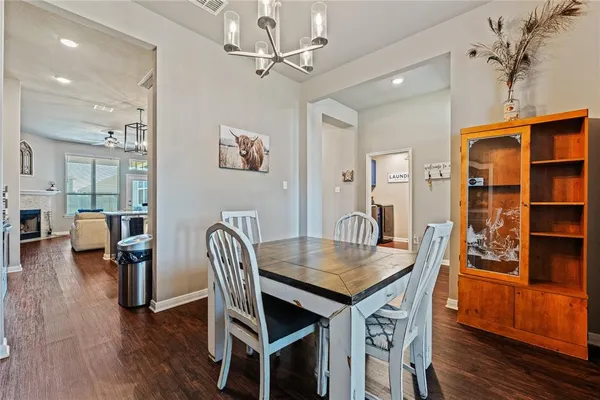 a dining room with furniture and wooden floor