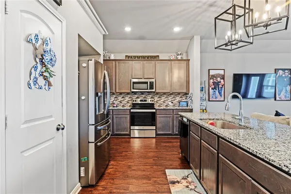 a kitchen with granite countertop stainless steel appliances a sink and counter space