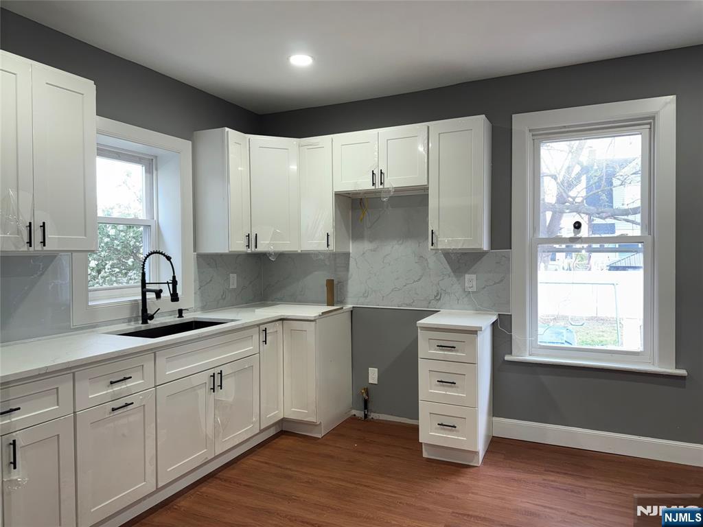 178 Berry Street Hackensack, NJ 07601 - Photo 7 of 22 a kitchen with a white cabinets and window