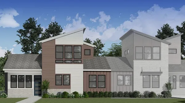 a aerial view of a brick house next to a yard