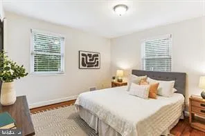 a bedroom with a bed and a potted plant