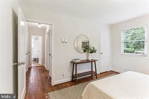 a bedroom with a bed and a mirror