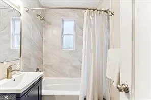 a bathroom with a shower curtain and a sink