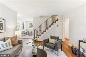 a living room with furniture and a dining table