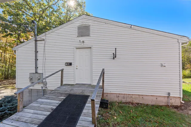 a view of a white house with a yard