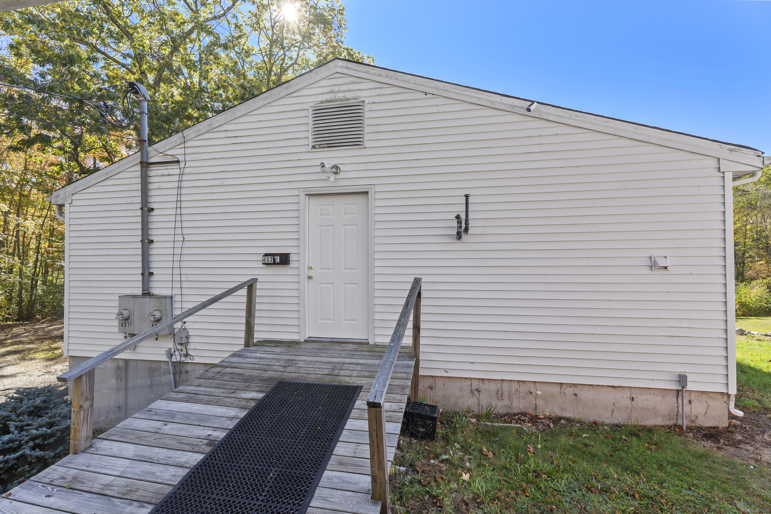 a view of a white house with a yard