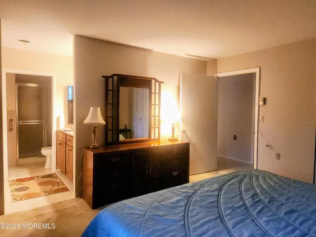 a bedroom with a bed and a dresser