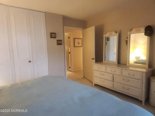 a spacious bathroom with a granite countertop sink and a mirror