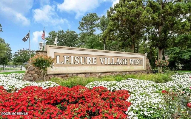 a sign that is in front of flowers