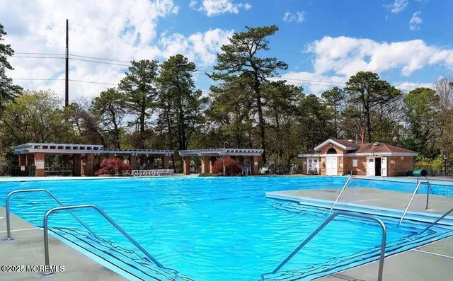 a view of pool with chairs