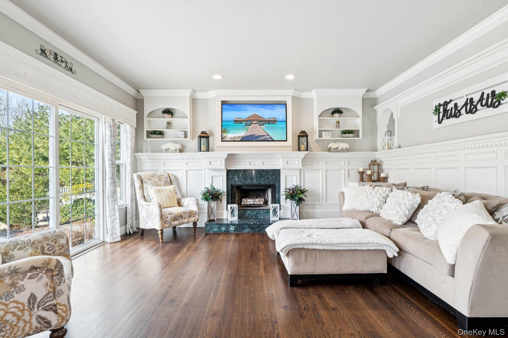 7 Brittany Court Ridge, NY 11961 - Photo 12 of 45 Living area with built in features, crown molding, a fireplace, dark wood-style flooring, and recessed lighting