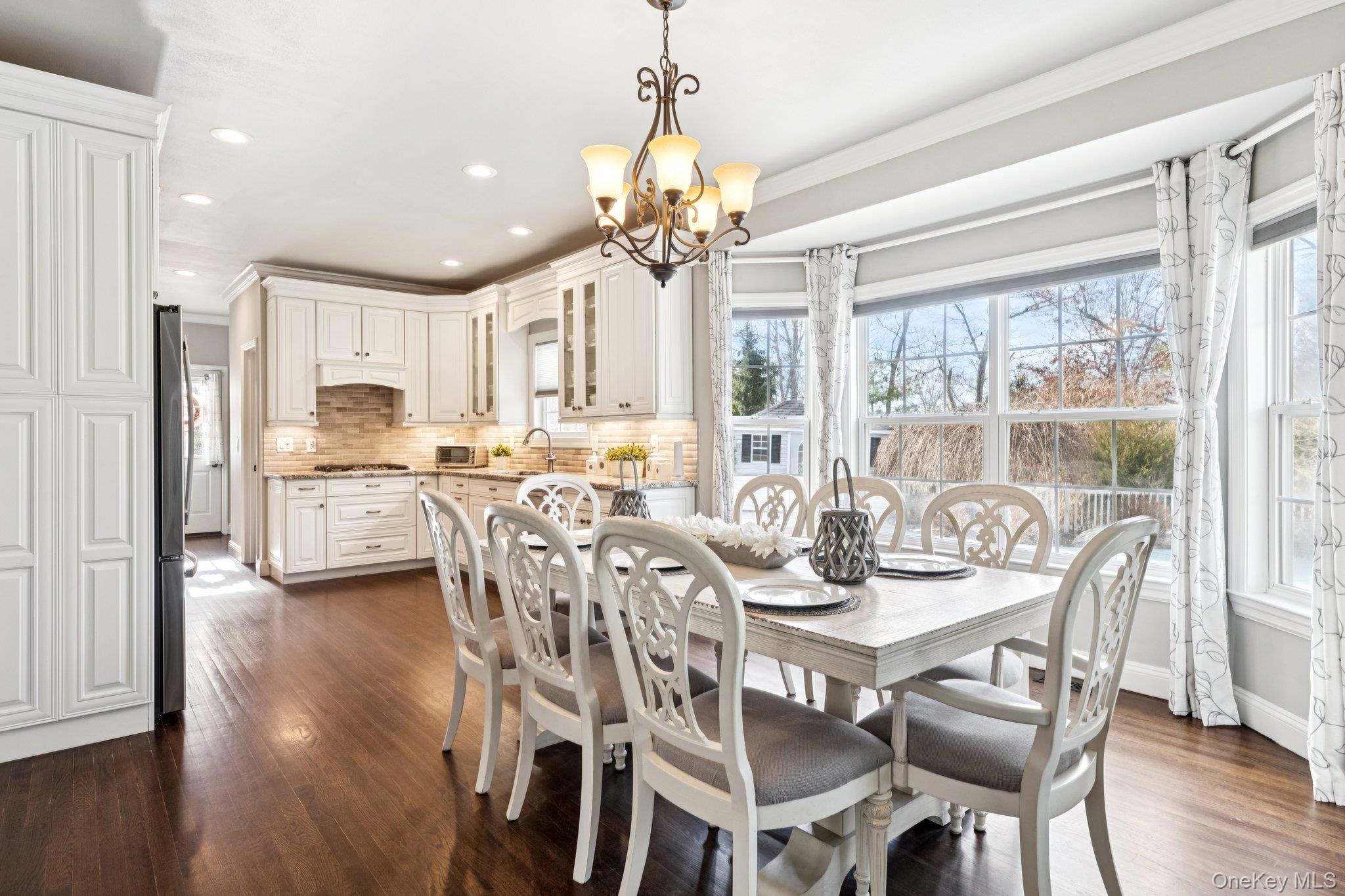 7 Brittany Court Ridge, NY 11961 - Photo 16 of 45 Dining area featuring a chandelier, dark wood-style flooring, recessed lighting, and crown molding