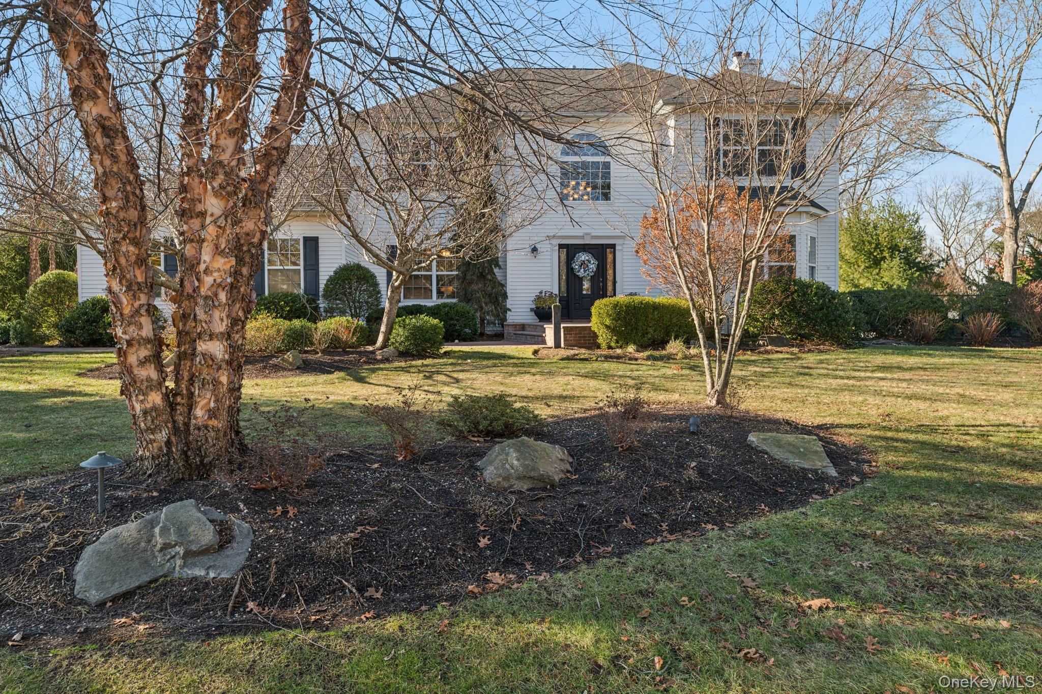 7 Brittany Court Ridge, NY 11961 - Photo 2 of 45 View of front of home featuring a front yard and a chimney