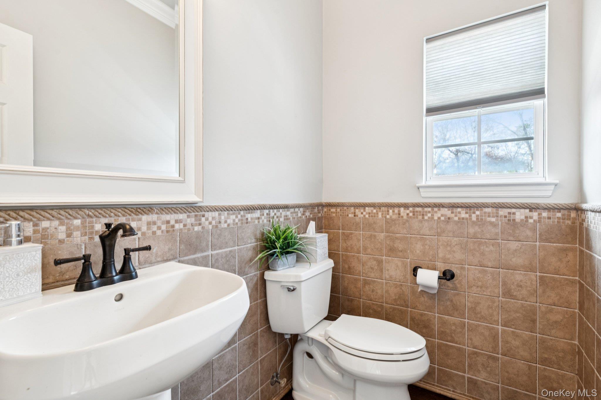 7 Brittany Court Ridge, NY 11961 - Photo 23 of 45 Bathroom with a sink and a wainscoted wall