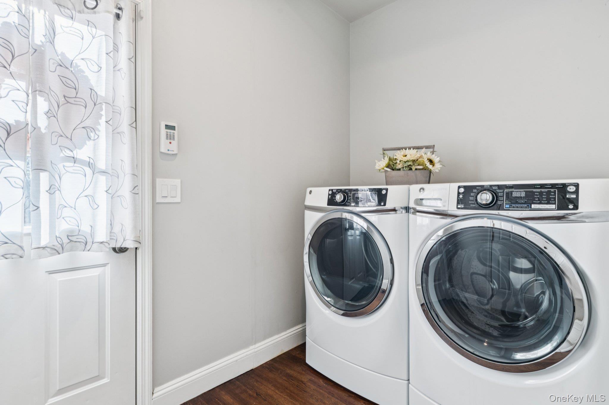 7 Brittany Court Ridge, NY 11961 - Photo 24 of 45 Laundry room featuring washing machine and clothes dryer and dark wood-style flooring