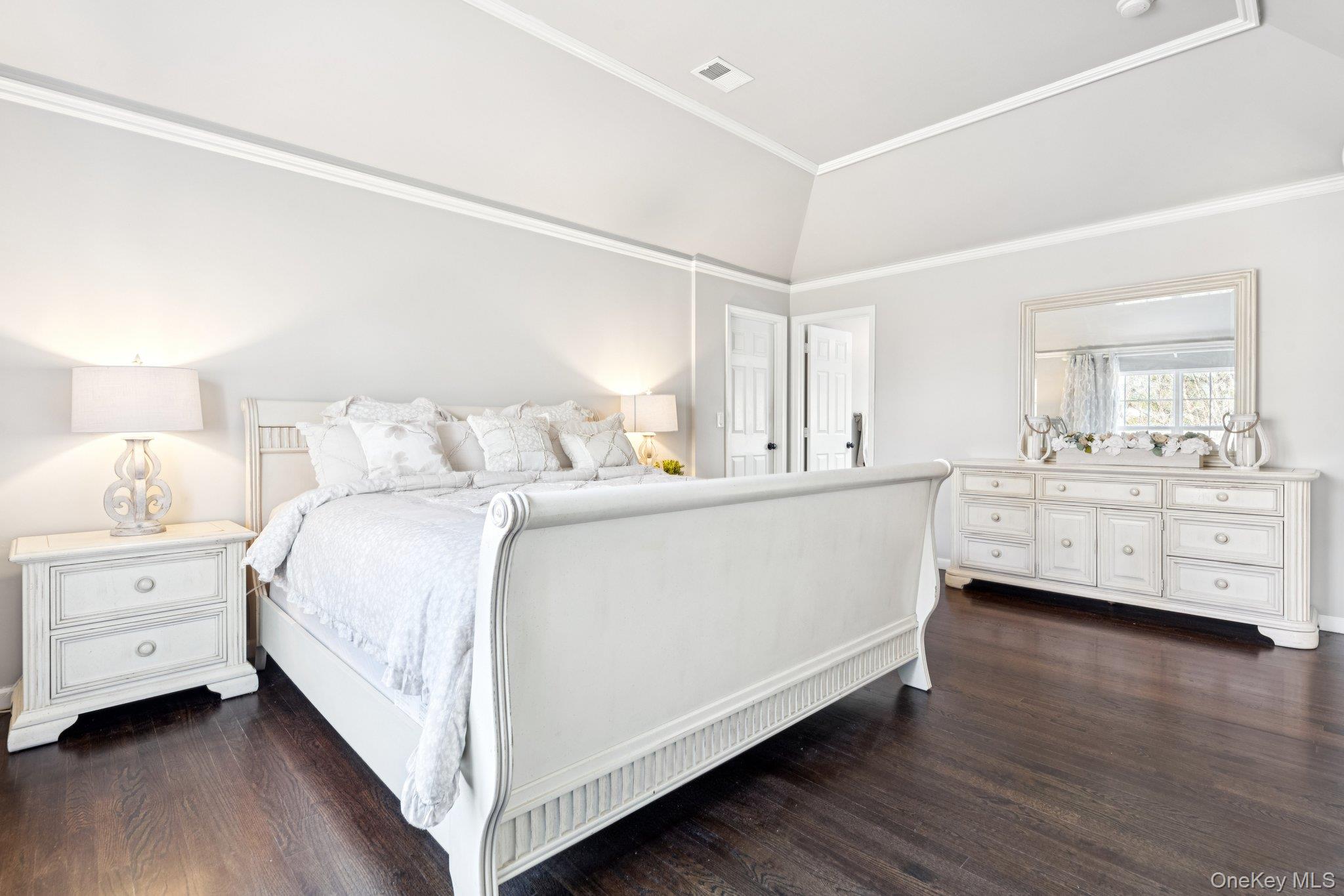 7 Brittany Court Ridge, NY 11961 - Photo 30 of 45 Bedroom featuring dark wood finished floors, crown molding, and lofted ceiling