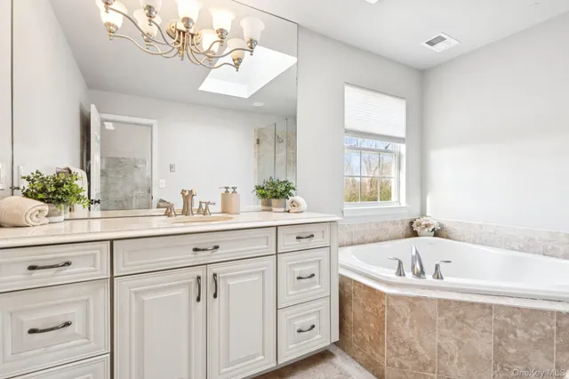a white bath tub sitting next to a bathroom sink