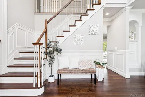 a view of entryway and hall with wooden floor