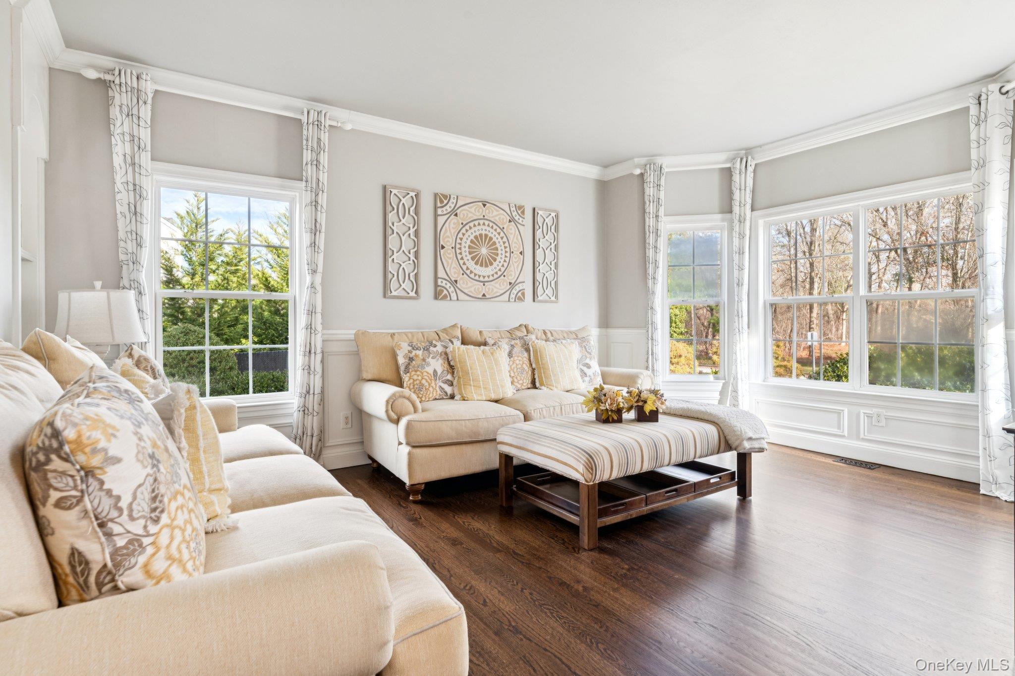 7 Brittany Court Ridge, NY 11961 - Photo 9 of 45 Bedroom with wainscoting, crown molding, wood finished floors, a decorative wall, and multiple windows
