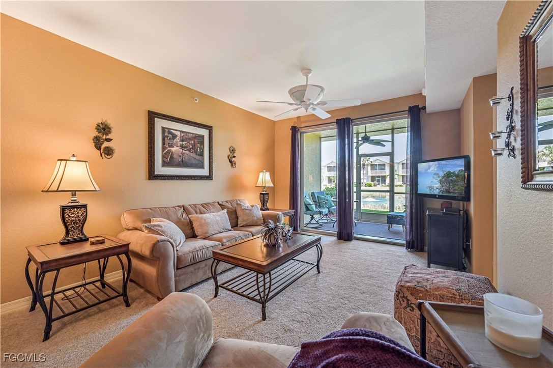 20201 Estero Gardens Circle, Unit 103 Estero, FL 33928 - Photo 13 of 33 a living room with furniture a lamp and a window