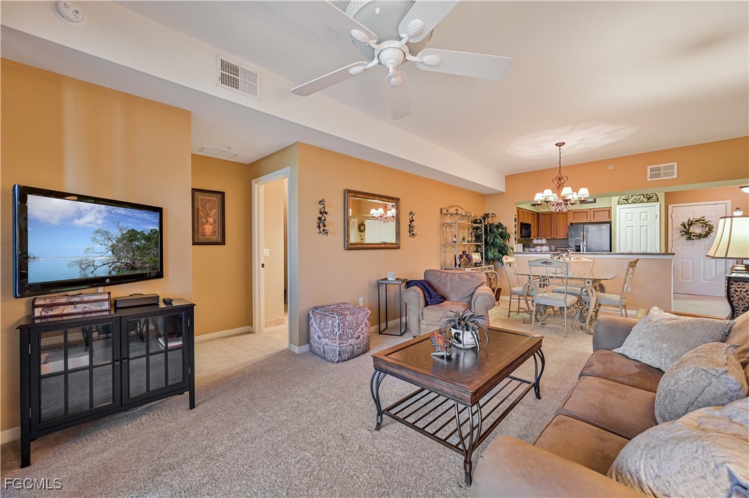 20201 Estero Gardens Circle, Unit 103 Estero, FL 33928 - Photo 14 of 33 a living room with furniture and a flat screen tv