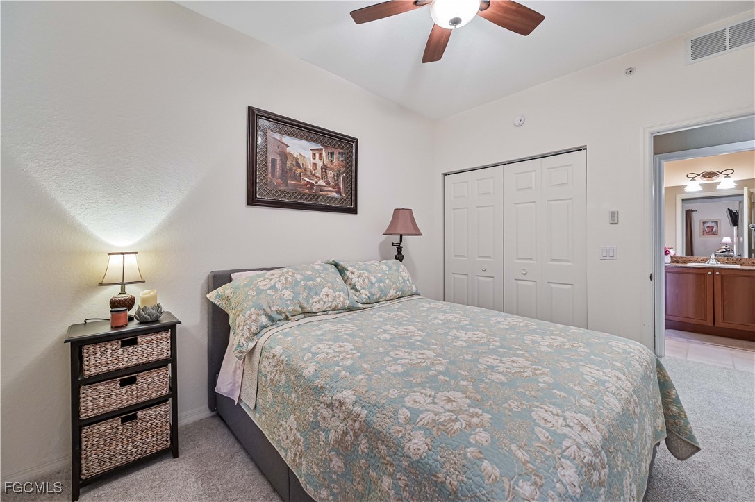 20201 Estero Gardens Circle, Unit 103 Estero, FL 33928 - Photo 17 of 33 a bedroom with a bed and a chandelier