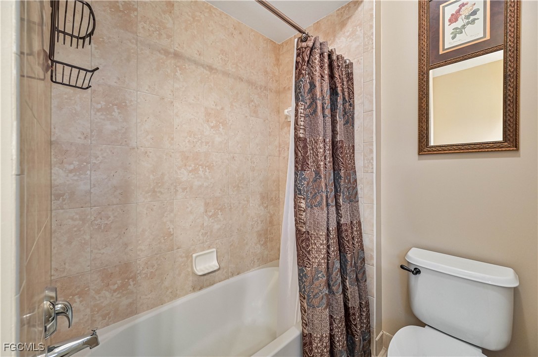 20201 Estero Gardens Circle, Unit 103 Estero, FL 33928 - Photo 20 of 33 a bathroom with a toilet and a shower