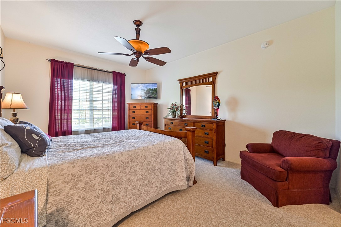 20201 Estero Gardens Circle, Unit 103 Estero, FL 33928 - Photo 22 of 33 a bedroom with a bed couch and window