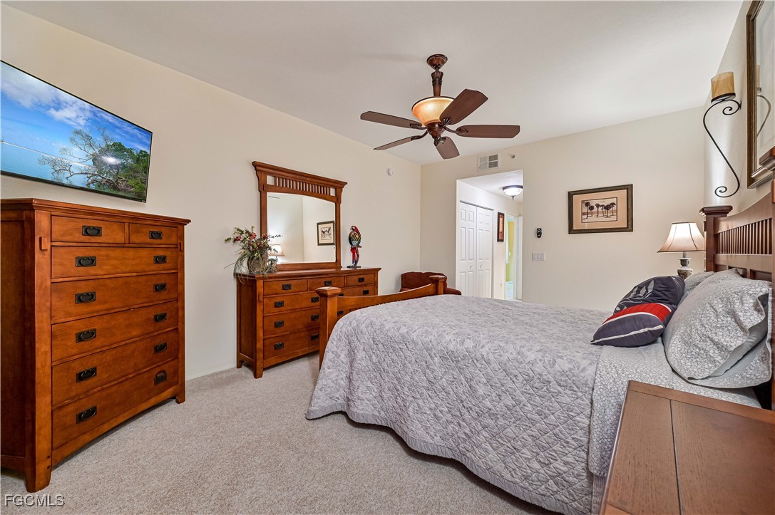 20201 Estero Gardens Circle, Unit 103 Estero, FL 33928 - Photo 23 of 33 a bedroom with a bed and a chandelier