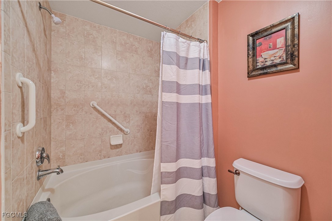 20201 Estero Gardens Circle, Unit 103 Estero, FL 33928 - Photo 25 of 33 a bathroom with a toilet and a shower