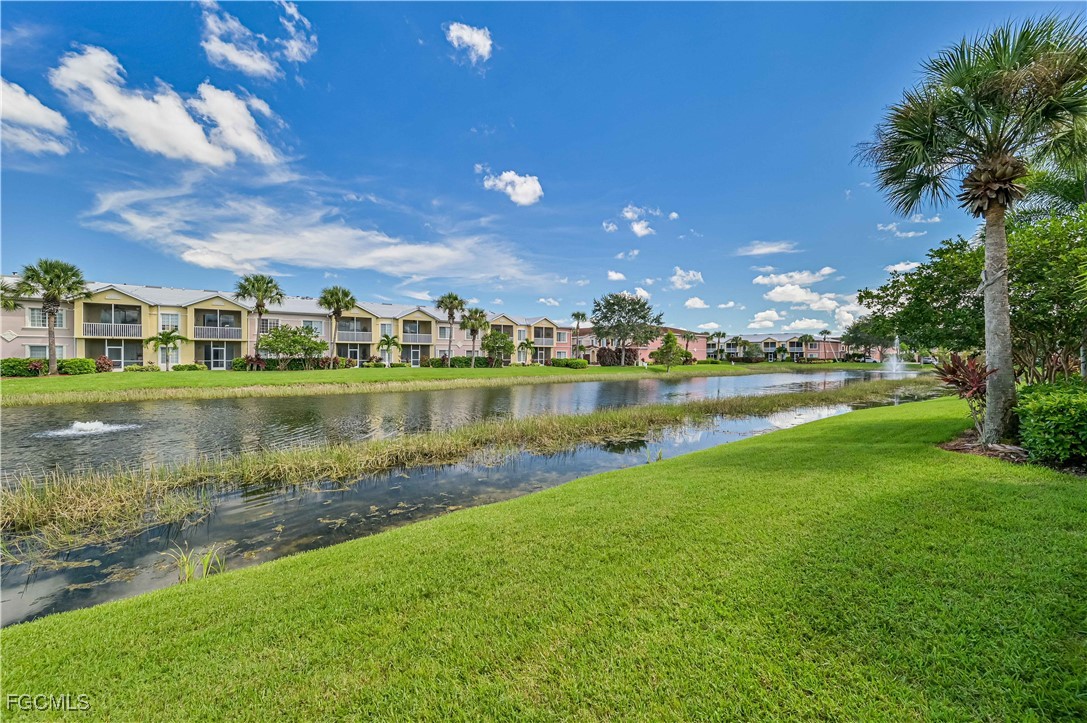 20201 Estero Gardens Circle, Unit 103 Estero, FL 33928 - Photo 27 of 33 a view of a lake with a house in the background