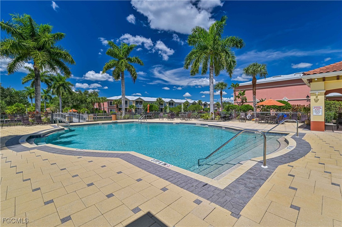 20201 Estero Gardens Circle, Unit 103 Estero, FL 33928 - Photo 29 of 33 a view of a swimming pool with a lounge chairs