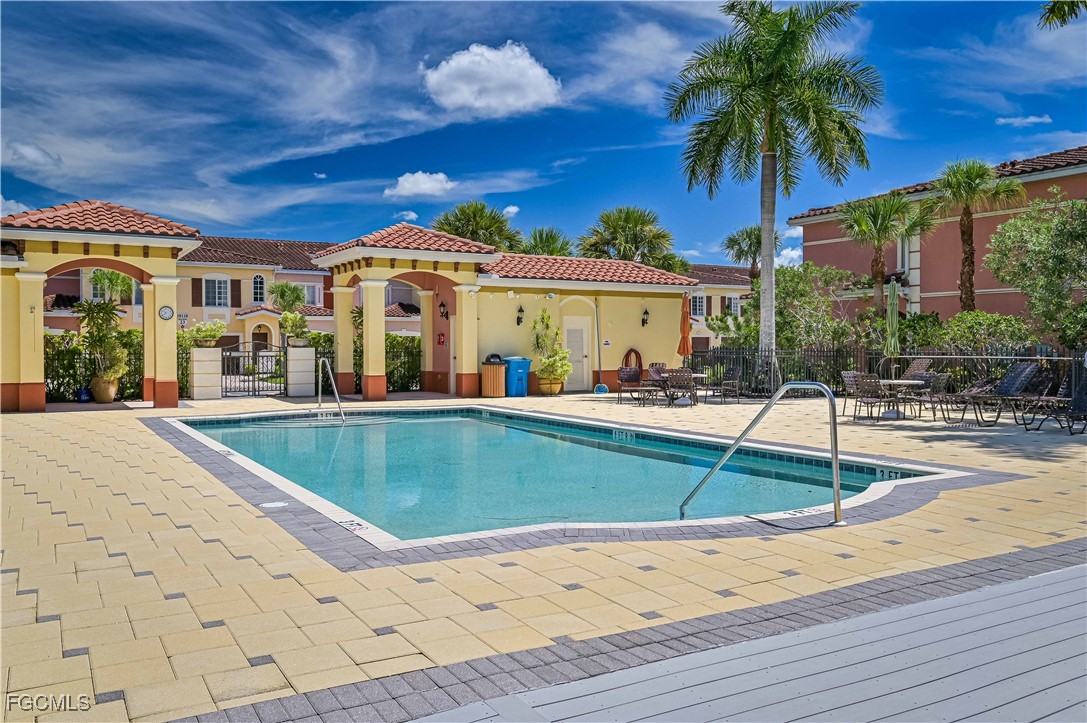 20201 Estero Gardens Circle, Unit 103 Estero, FL 33928 - Photo 31 of 33 a view of a house with swimming pool and sitting area