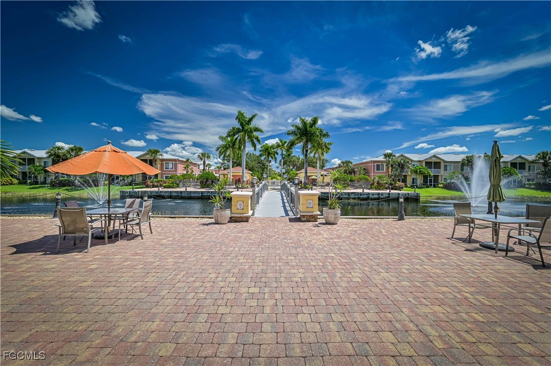 20201 Estero Gardens Circle, Unit 103 Estero, FL 33928 - Photo 32 of 33 a view of a swimming pool with a patio