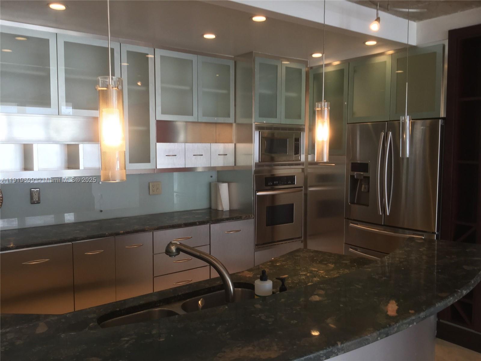 1408 Brickell Bay Drive, Unit 612 Miami, FL 33131 - Photo 11 of 27 a kitchen with stainless steel appliances a sink stove and refrigerator