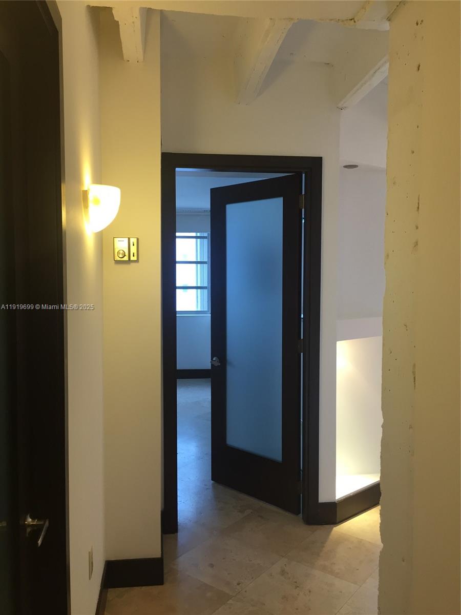 1408 Brickell Bay Drive, Unit 612 Miami, FL 33131 - Photo 13 of 27 a view of a hallway with wooden shelves