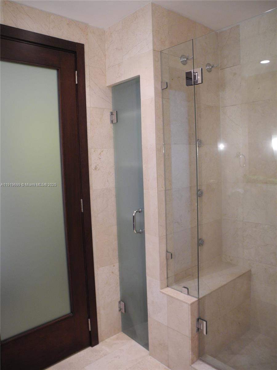 1408 Brickell Bay Drive, Unit 612 Miami, FL 33131 - Photo 20 of 27 a bathroom with a shower and a toilet