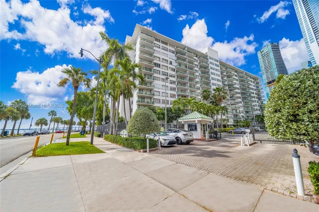 a view of a big room with wooden floor and chandelier