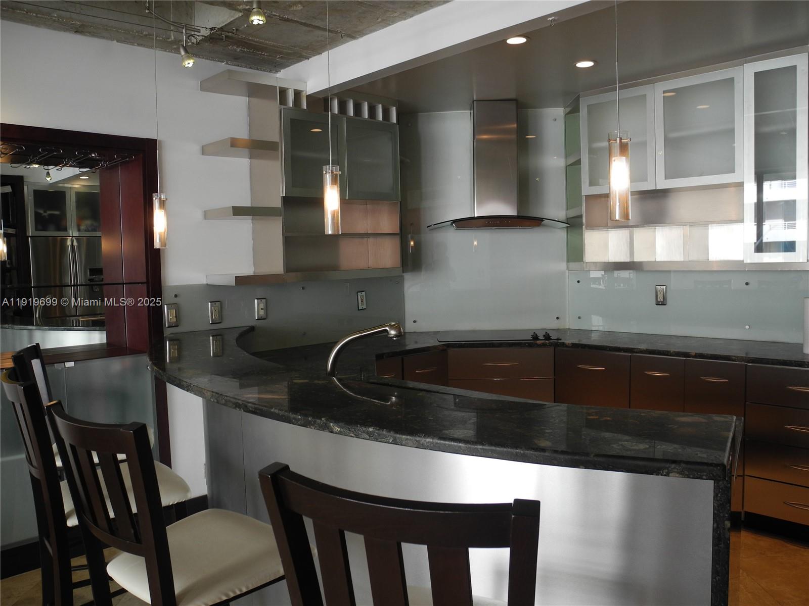 1408 Brickell Bay Drive, Unit 612 Miami, FL 33131 - Photo 8 of 27 a kitchen with a sink cabinets and wooden floor