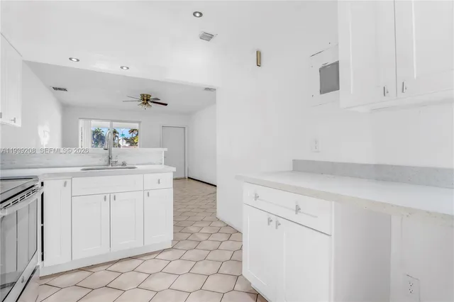 a kitchen with white cabinets