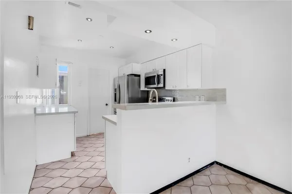 a kitchen with sink cabinets and microwave