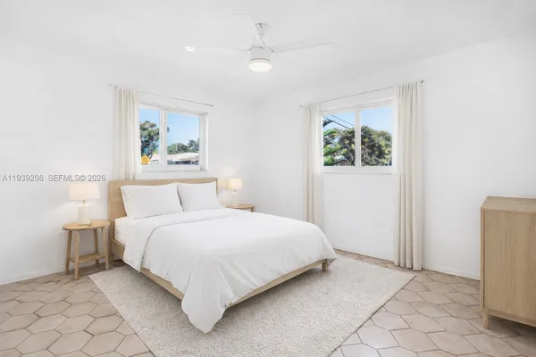 a bedroom with a bed and a painting on the wall