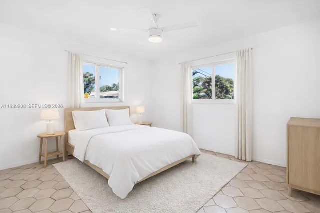 a bedroom with a bed and a painting on the wall