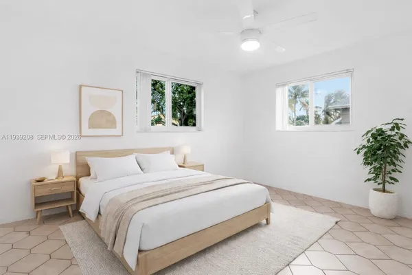 a bedroom with a bed and a painting on the wall