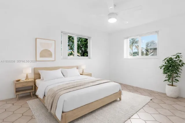 a bedroom with a bed and a painting on the wall