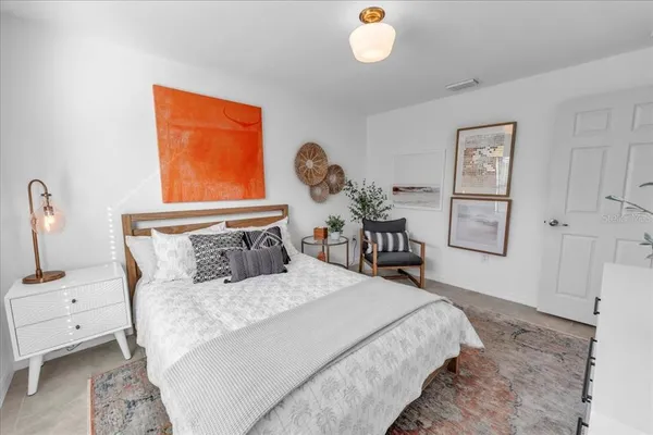 a living room with furniture and a potted plant