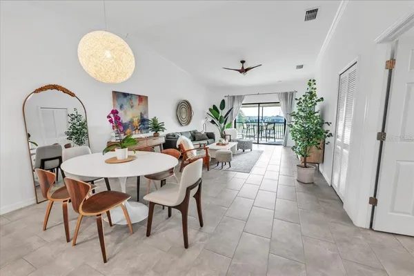 a bedroom with a large bed and a potted plant