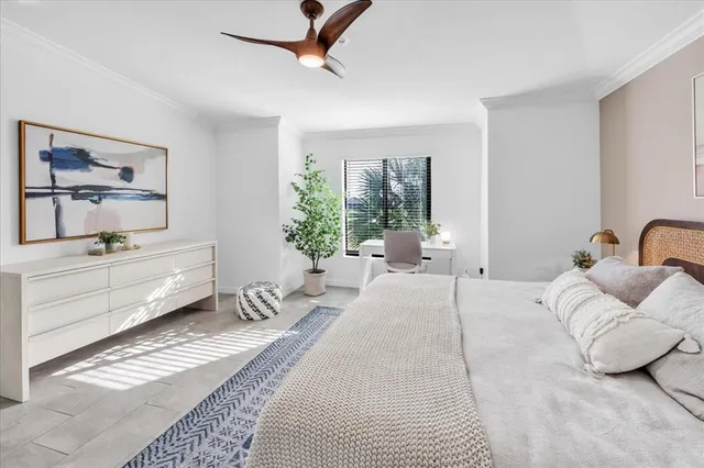 a dining room with furniture and chandelier fan