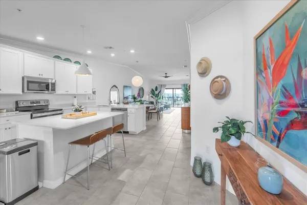 a kitchen with stainless steel appliances granite countertop a refrigerator oven a sink a stove and white cabinets